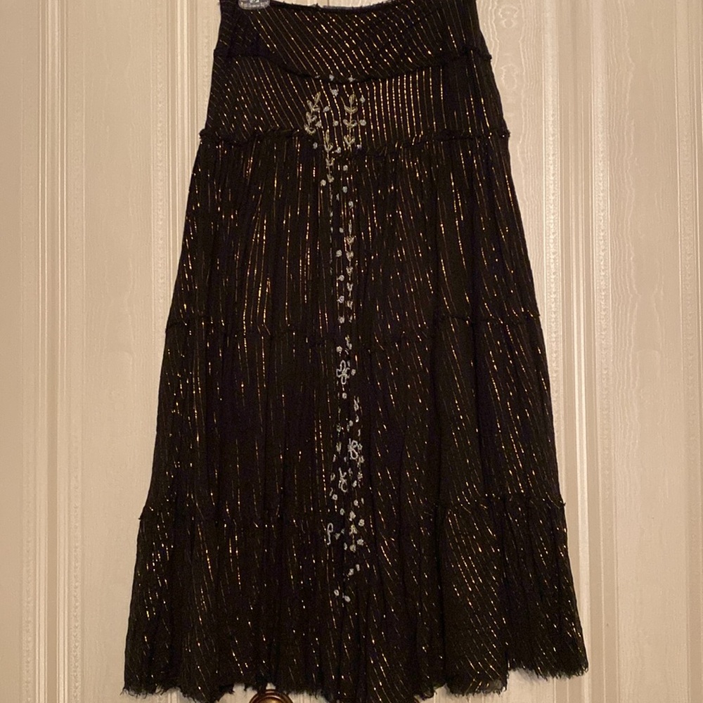 Elegant Black with Gold metallic threads and beaded accent down front of skirt.